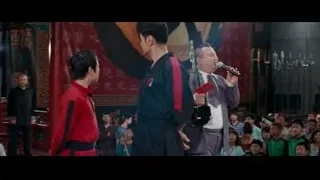 three men on stage one speaking — The Karate Kid