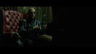 bald man holding gun in leather armchair — The Matrix