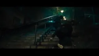 man walking up dark alley stairs — John Wick: Chapter 4