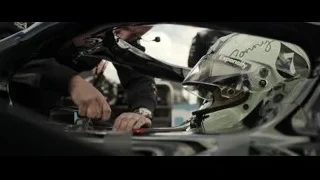 Motorcycle helmet resting on motorcycle at race track — F1