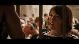 young woman looking out from behind bars — Gladiator