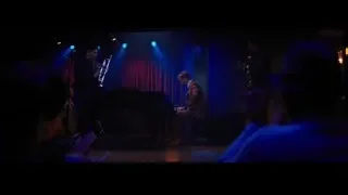 band performing on stage with red curtain — La La Land