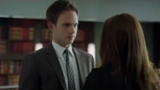 Man and woman in serious library conversation — Suits