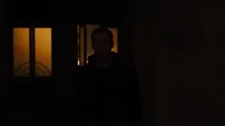 Man standing in dimly lit room by window — Blade Runner 2049
