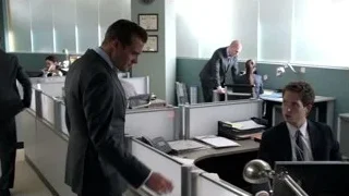 Man in suit walking through office cubicle — Suits