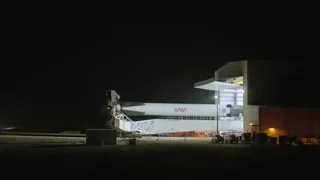 NASA rocket in hangar at night — Elon Musk: Return to Space