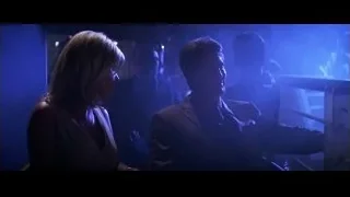 man and woman in dimly lit blue room — Batman: The Dark Knight