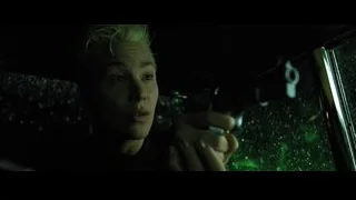 Young woman holding gun in dark car — The Matrix