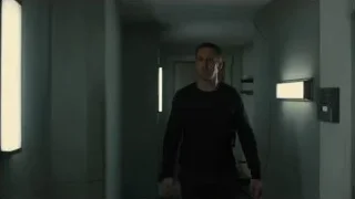 man walking in dimly lit hallway — Blade Runner 2049