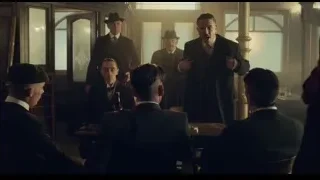 man speaking to group in dimly lit room — Peaky Blinders