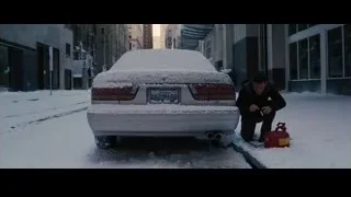 man with fire extinguisher by snowy car — Batman: The Dark Knight Rises