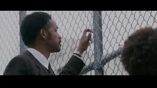 man in suit pointing by fence — The Persuit of Happyness