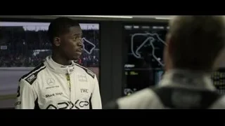 young man in racing suit control room — F1