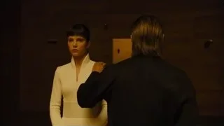 woman standing in dimly lit room — Blade Runner 2049