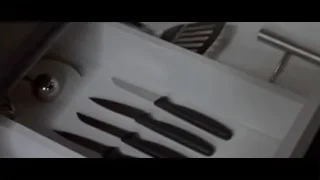 Hand reaching for knife in drawer — American Psycho