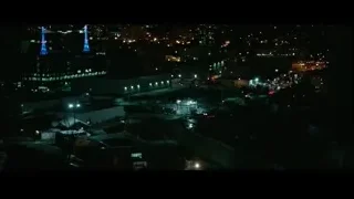 Aerial night view of city with blue tower — John Wick