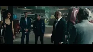 men in a garage with a car — Furious Seven