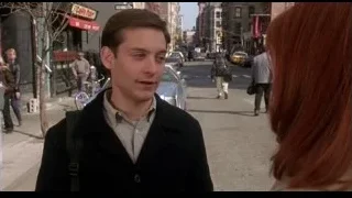 young man and woman on busy street — Spider Man