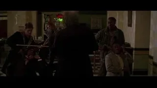 Men conversing in a dimly lit bar — Batman: The Dark Knight