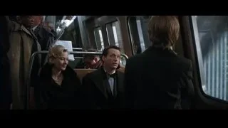 people on train looking at cityscape — Batman