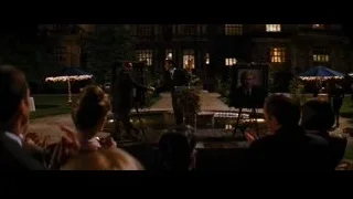 people gathered in garden for speech at night — Batman: The Dark Knight Rises