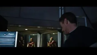 Man standing in room with Iron Man suits — Iron Man 3