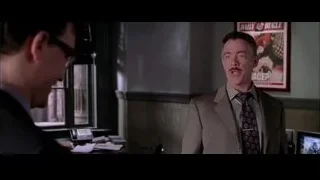 Two men talking in office with Daily Bugle poster — Spider Man 2