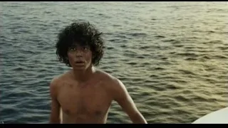 Young man on cliff overlooking ocean — Life of Pi