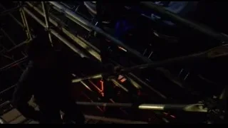 man working on metal structure in dark room — Spider Man