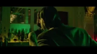Man and woman talking in dimly lit bar — John Wick