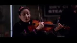 woman playing violin on stage — Spider Man 2