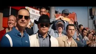 men in stadium with red truck — Ford v Ferrari