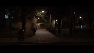 street at night with lit building — Southpaw