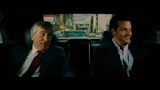 two men conversing in car on city street — Limitless
