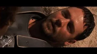 Man in armor deep in thought on sand — Gladiator