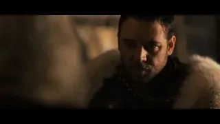 man in fur coat in dimly lit room — Gladiator