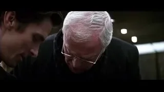 two men looking down in dim room — Batman: The Dark Knight