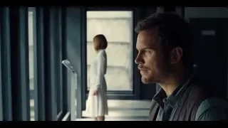 Man and woman standing by large window — Jurassic World