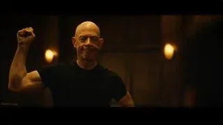 Bald man in dimly lit room exercising — Whiplash