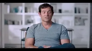 Man in t-shirt sitting in living room — The Social Dilemma