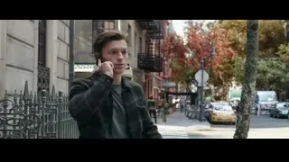 Young man talking on phone on city street — Spiderman: No Way Home