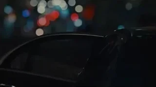 person in car at night with colorful lights — Succession