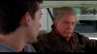 Two men with serious expressions in car — Spider Man