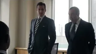 two men in suits conversing in office — Suits