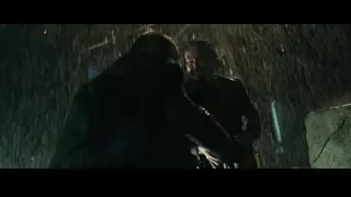 hooded person holding gun in rain — John Wick