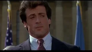 man in suit speaking into microphone — Rocky III