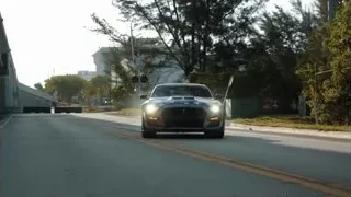 Black sports car driving on road — Sports Cars