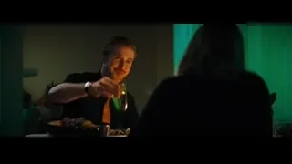 man and woman at table in dimly lit restaurant — La La Land