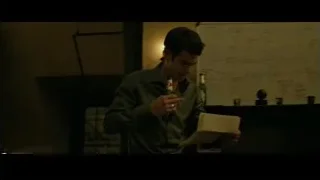 young man holding beer in dim room — The Social Network