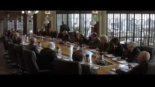 People sitting at conference table with city view — Batman